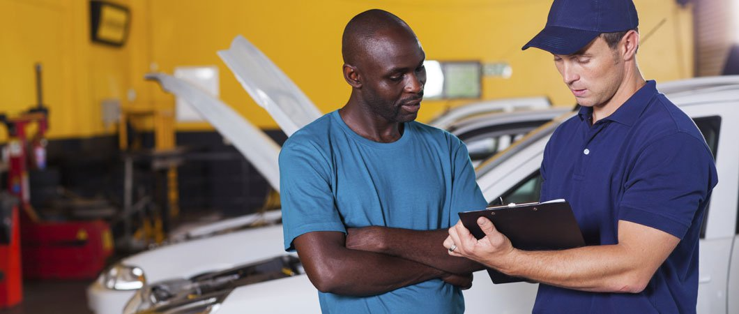A Service Rep looks over a clip board with a client